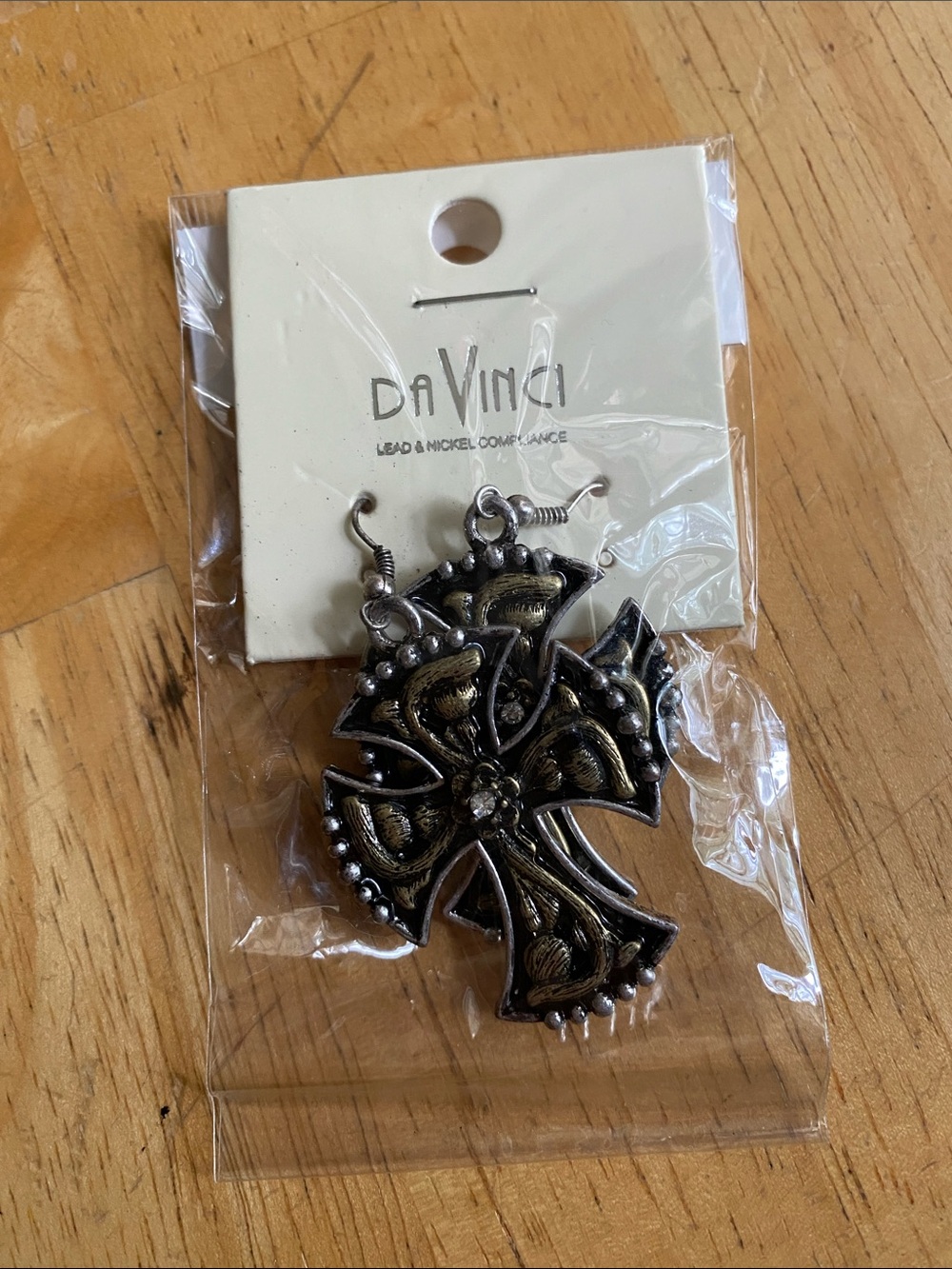 These earrings are ornate flared cross dangles from the brand DaVinci.